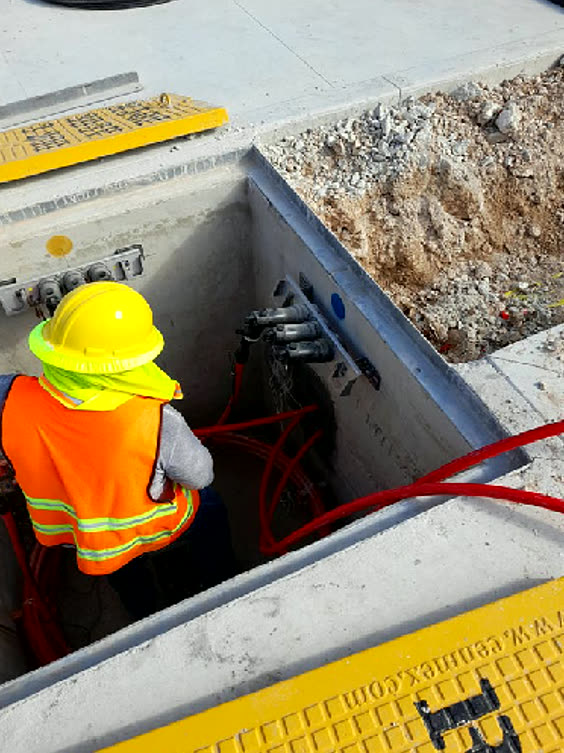 Técnico rematando los conductores dentro del registro eléctrico